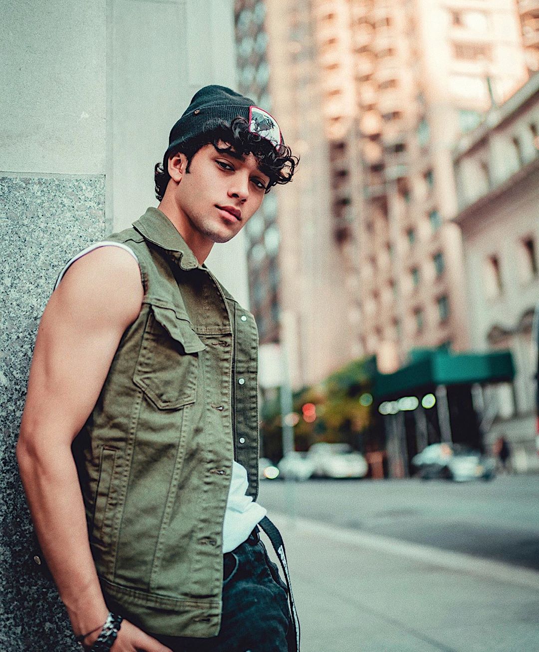 Joel Pimentel Standing With a Green Sleeveless Jacket On